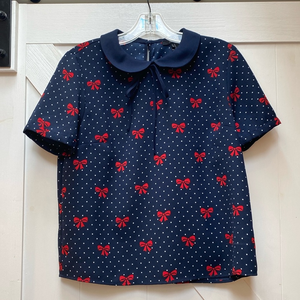 Peter Pan collar blouse with bows on it. Size medium.